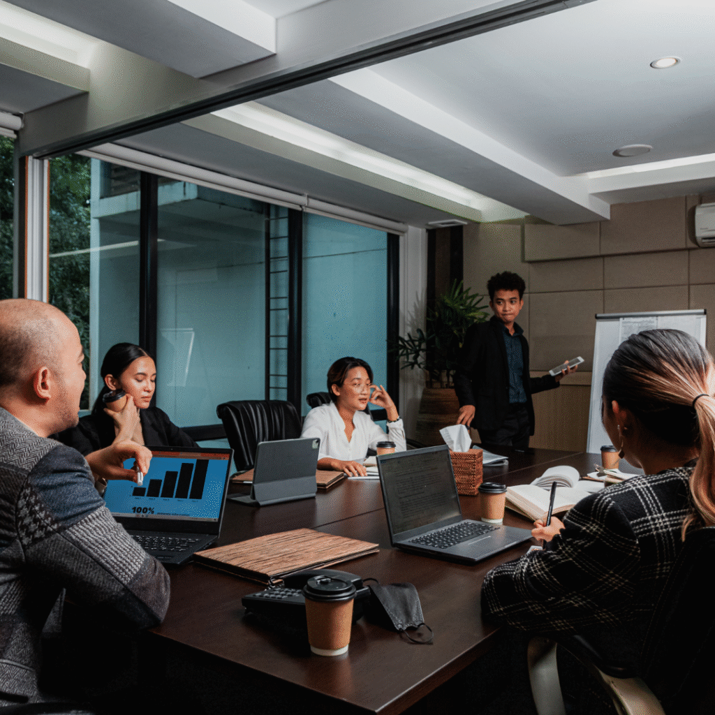 Structure Without Overwhelm – Veritas Consulting | Simplifying HR & Business Systems for Growth Corporate team in a structured yet relaxed office meeting, reflecting streamlined business systems, clarity, and people-focused workplace practices.