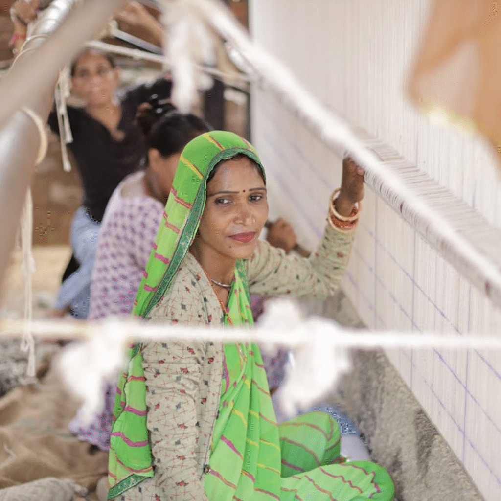 MSME-Focused & People-First Consulting – Veritas Consulting | Enabling Inclusive Growth Woman working at a traditional weaving site, representing MSME-focused, people-first consulting that empowers grassroots businesses and promotes inclusive growth.