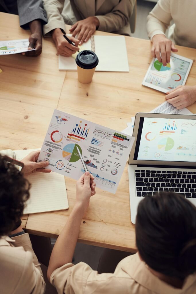 Data-Driven Consulting Team – Veritas Services Page Business consultants analyzing charts, graphs, and data dashboards during a strategy meeting, highlighting Veritas Consulting's insight-driven services